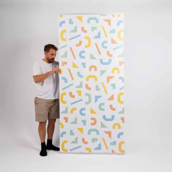 zoli standing next to a tension wall banner stand